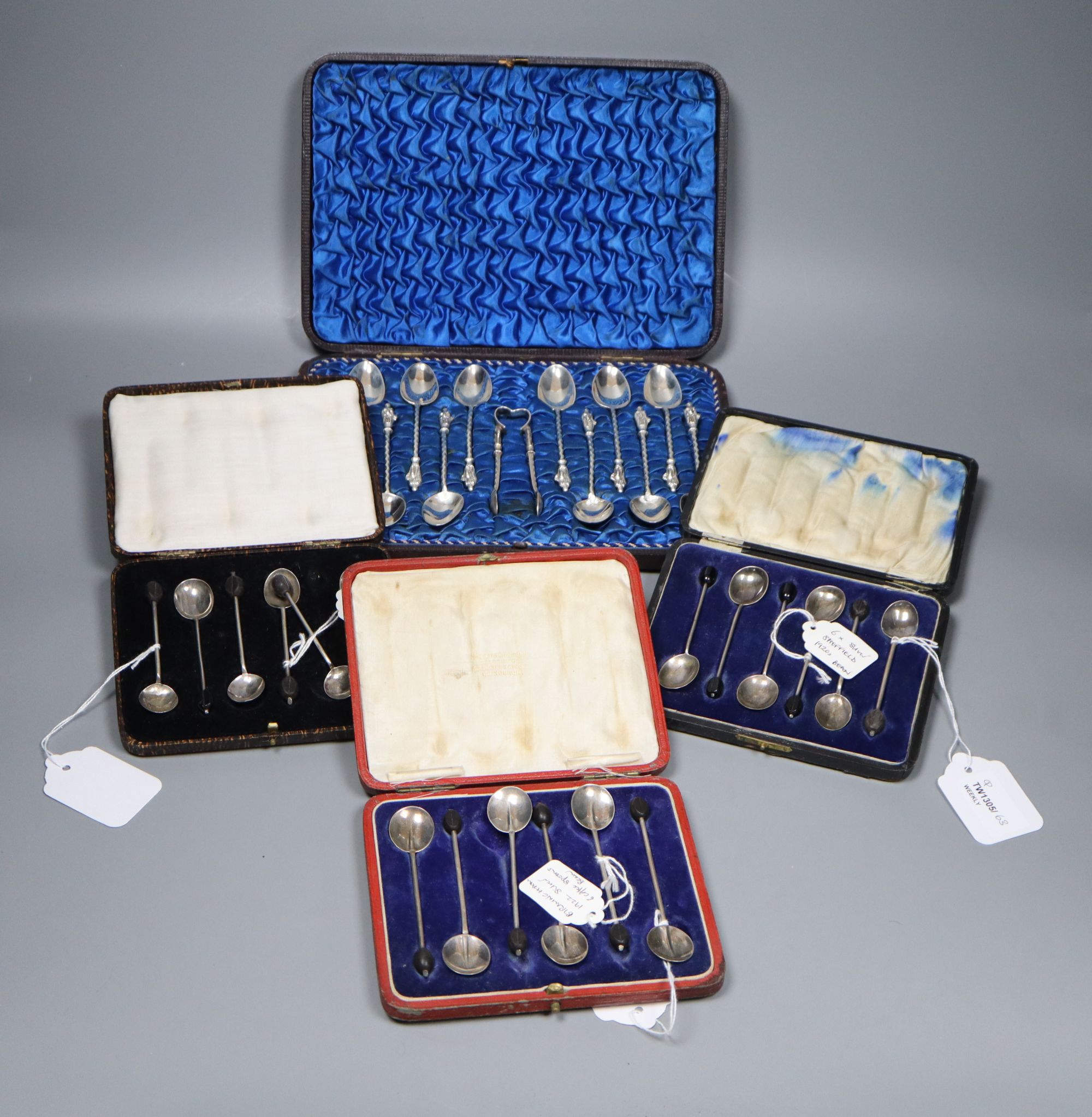 Twelve Victorian silver Apostle coffee spoons and sugar tongs, and three sets of six silver bean end coffee spoons, all cased